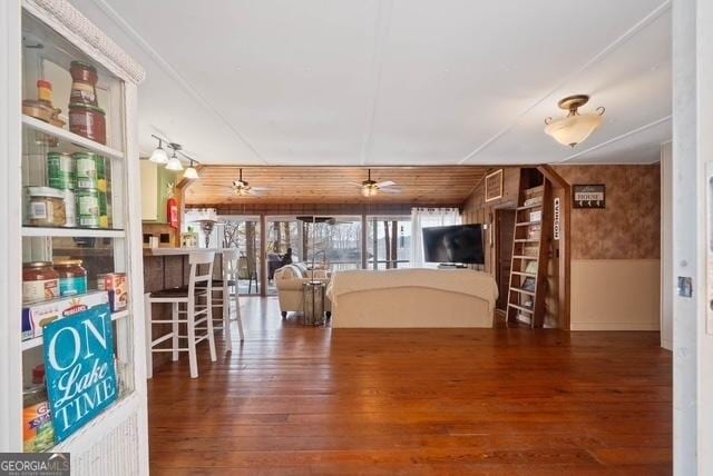 kitchen featuring a wainscoted wall, visible vents, wood finished floors, and a ceiling fan