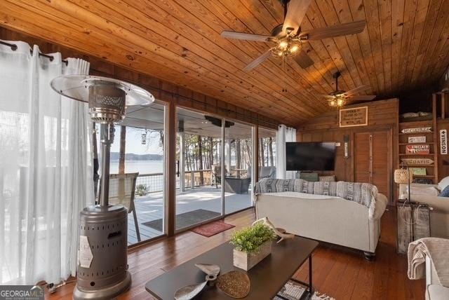 living area with lofted ceiling, wood ceiling, ceiling fan, and wood finished floors