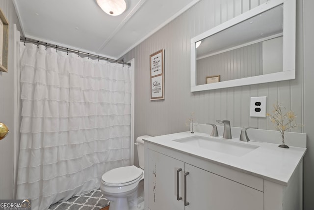 bathroom featuring toilet, curtained shower, and vanity