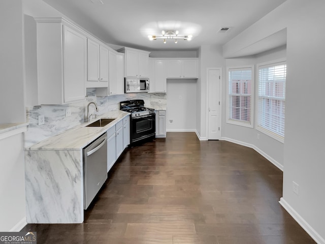 1235 Park Pass Way, Suwanee, GA 30024 - kitchen with visible vents, decorative backsplash, appliances with stainless steel finishes, white cabinets, and a sink