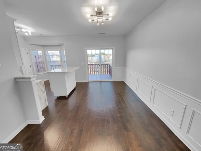 1235 Park Pass Way, Suwanee, GA 30024 - unfurnished dining area with dark wood finished floors, visible vents, and a decorative wall