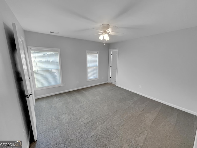 1235 Park Pass Way, Suwanee, GA 30024 - empty room featuring carpet floors, visible vents, ceiling fan, and baseboards