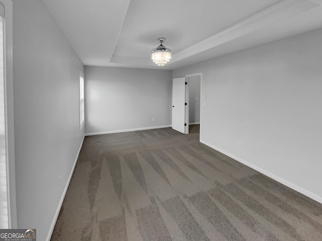 1235 Park Pass Way, Suwanee, GA 30024 - carpeted spare room featuring a tray ceiling, a notable chandelier, and baseboards