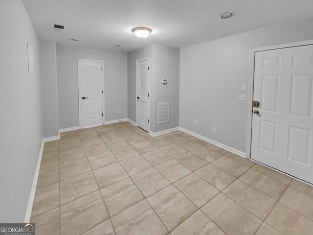 1235 Park Pass Way, Suwanee, GA 30024 - spare room featuring light tile patterned flooring, visible vents, and baseboards