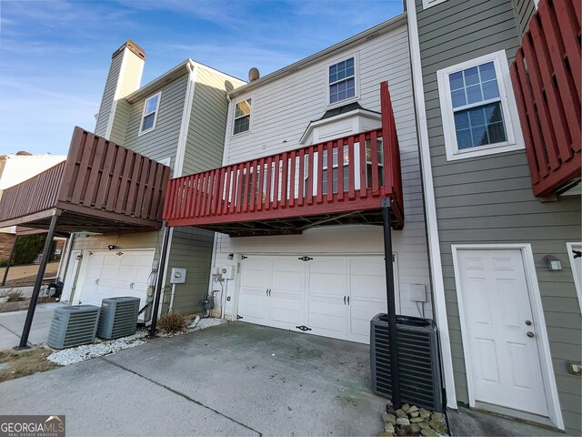 1235 Park Pass Way, Suwanee, GA 30024 - rear view of house with cooling unit and an attached garage