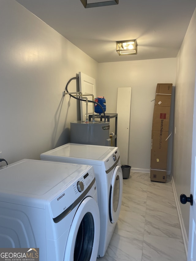 laundry area with laundry area, separate washer and dryer, baseboards, water heater, and marble finish floor