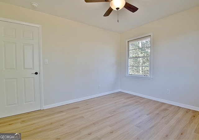 unfurnished room with a ceiling fan, baseboards, and wood finished floors