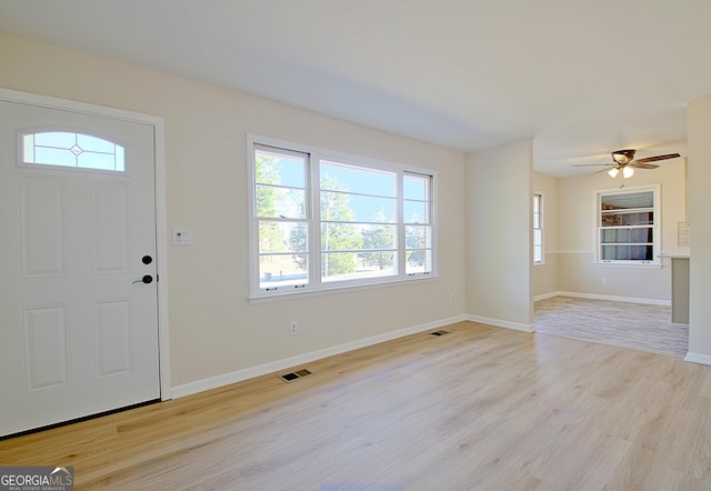 entrance foyer featuring light wood-style floors, baseboards, and visible vents