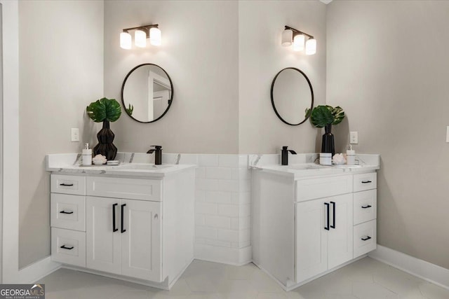 bathroom with two vanities and baseboards