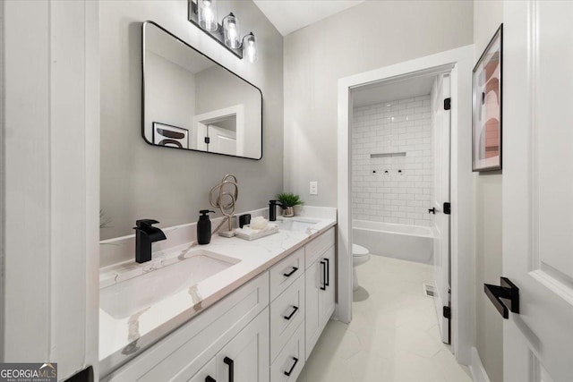 bathroom with toilet, double vanity, shower / washtub combination, and a sink