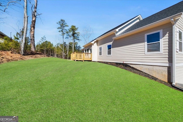 view of yard featuring a wooden deck