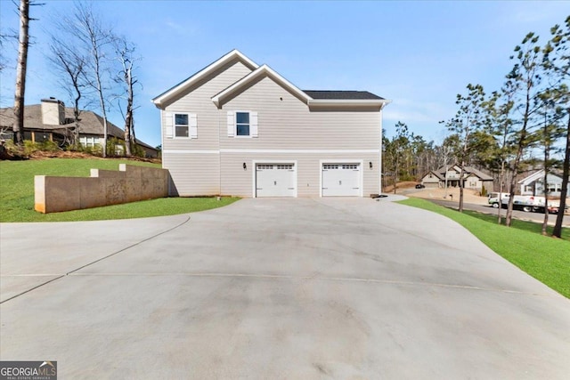 view of property exterior featuring a garage, concrete driveway, and a yard