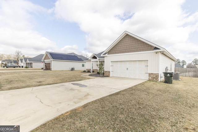 view of front of house featuring driveway, stone siding, an attached garage, fence, and cooling unit