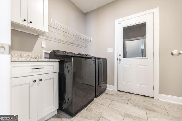 laundry area featuring cabinet space, baseboards, and separate washer and dryer