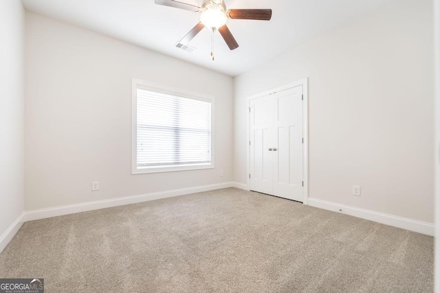 unfurnished bedroom with visible vents, baseboards, ceiling fan, and carpet flooring