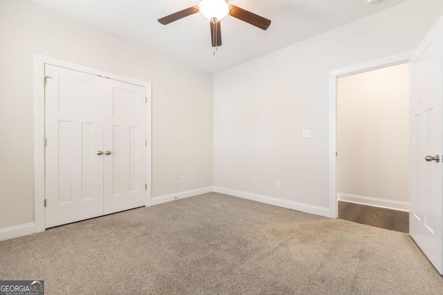 unfurnished bedroom featuring ceiling fan, a closet, baseboards, and carpet flooring