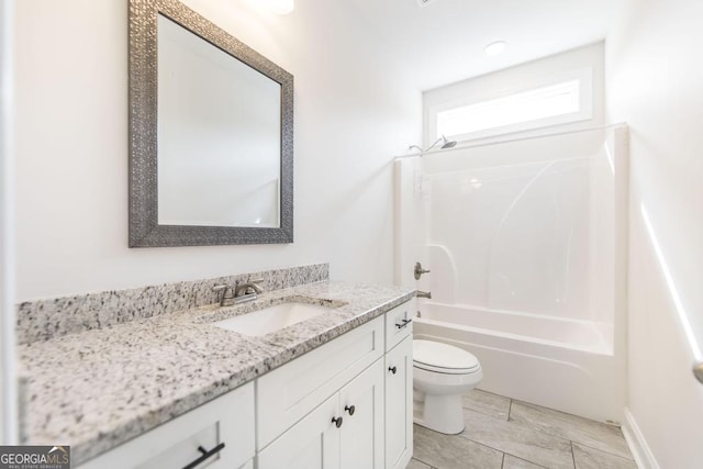 bathroom with washtub / shower combination, vanity, and toilet