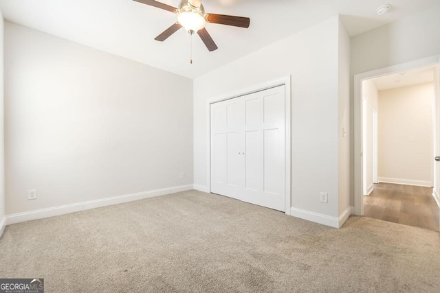 unfurnished bedroom featuring carpet, a closet, and baseboards