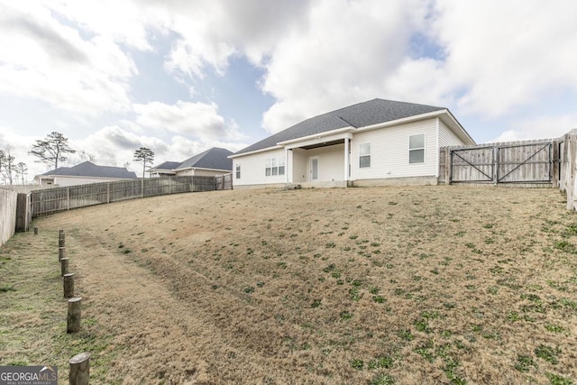 back of house featuring a fenced backyard