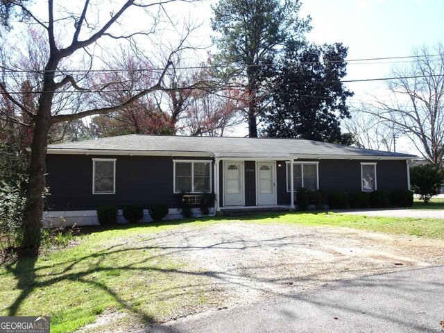 ranch-style home with a front yard and driveway