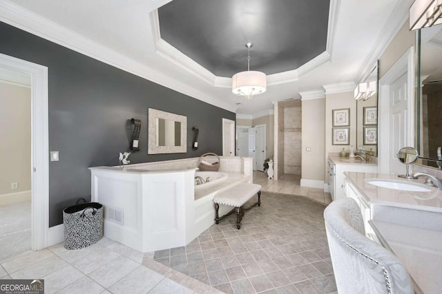 bathroom with a garden tub, a raised ceiling, a sink, and tile patterned floors