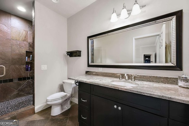 full bath with vanity, a shower stall, toilet, and baseboards