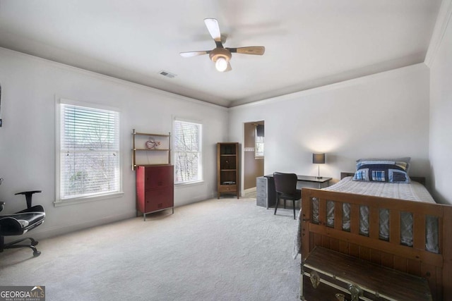 carpeted bedroom with visible vents, crown molding, baseboards, and ceiling fan