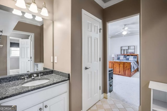 bathroom with crown molding, a ceiling fan, and vanity