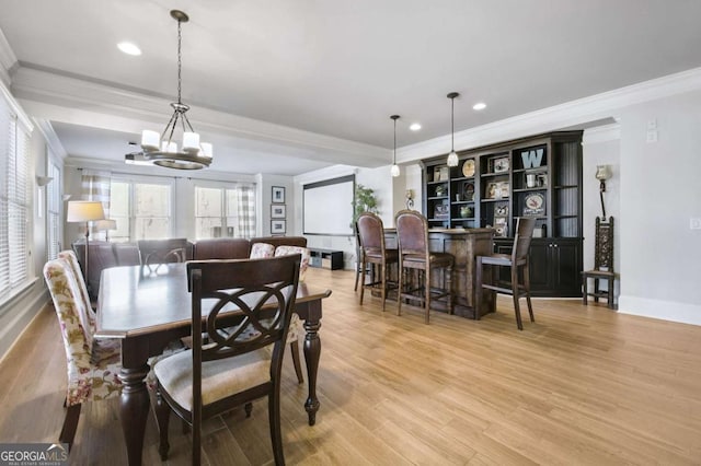 dining area featuring light wood finished floors, baseboards, crown molding, a chandelier, and recessed lighting