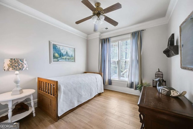 bedroom with light wood-type flooring, visible vents, and crown molding