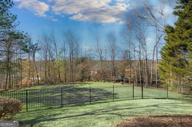 view of sport court featuring a lawn and fence