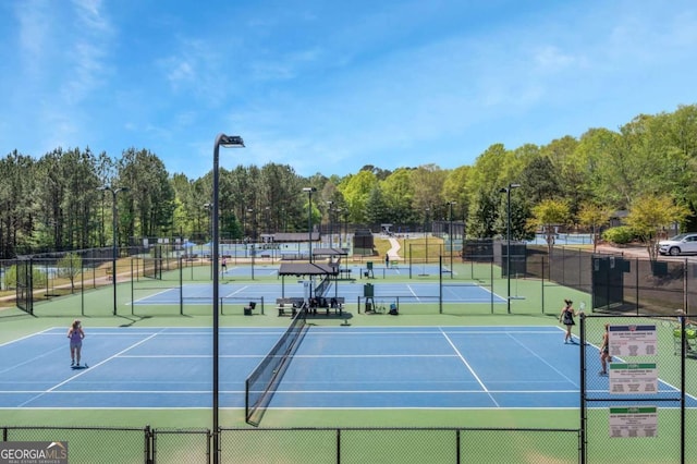 view of tennis court featuring fence