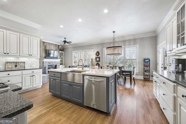 kitchen featuring a sink, white cabinetry, stainless steel dishwasher, gray cabinets, and crown molding