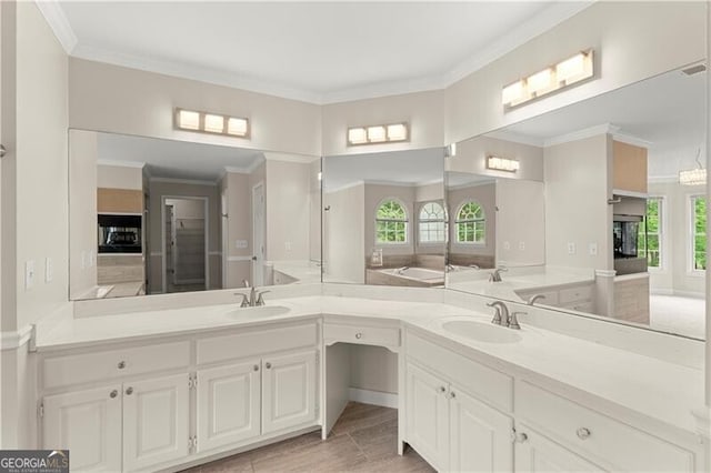 bathroom with ornamental molding and vanity