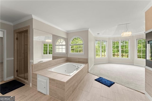 bathroom featuring a healthy amount of sunlight, a garden tub, and crown molding