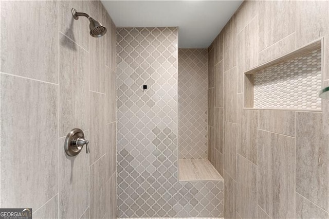 full bathroom with tiled shower