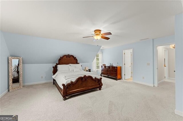 carpeted bedroom with ceiling fan, lofted ceiling, and baseboards