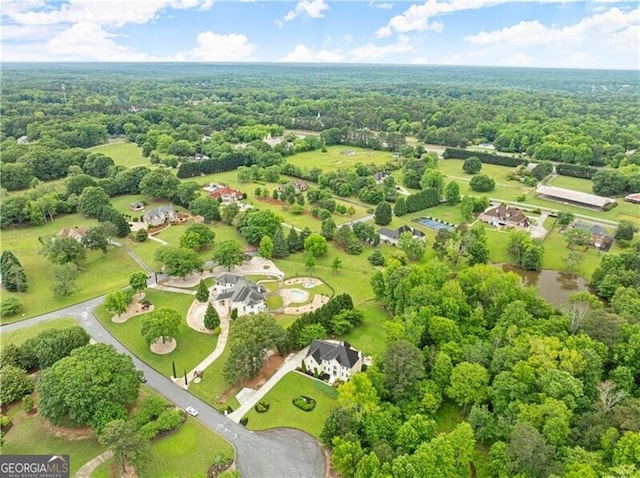 bird's eye view featuring a wooded view