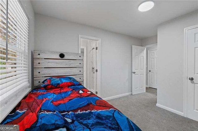 carpeted bedroom with baseboards