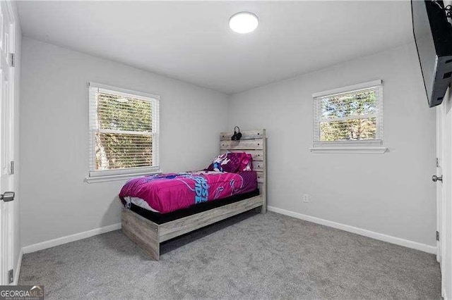 bedroom with carpet floors and baseboards