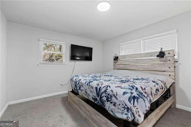 carpeted bedroom featuring baseboards