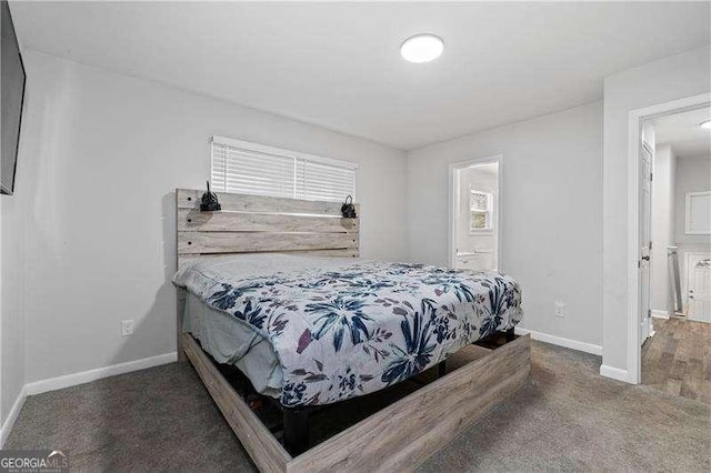 carpeted bedroom featuring baseboards