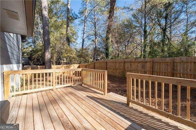 wooden terrace featuring a fenced backyard