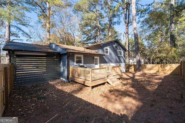 back of property with a fenced backyard and a wooden deck