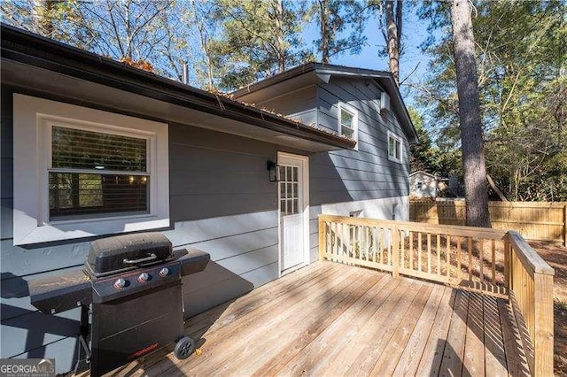 wooden terrace featuring fence and area for grilling