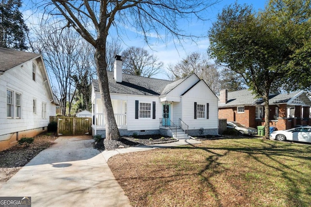 view of front of property featuring a chimney, roof with shingles, crawl space, fence, and a front yard