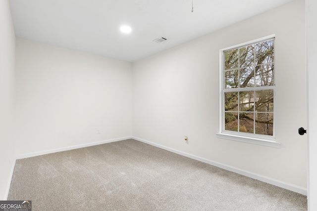 carpeted spare room with recessed lighting, visible vents, and baseboards