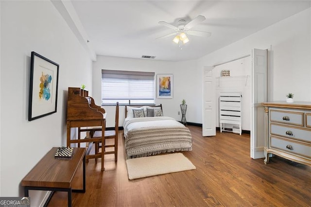 bedroom featuring visible vents and wood finished floors