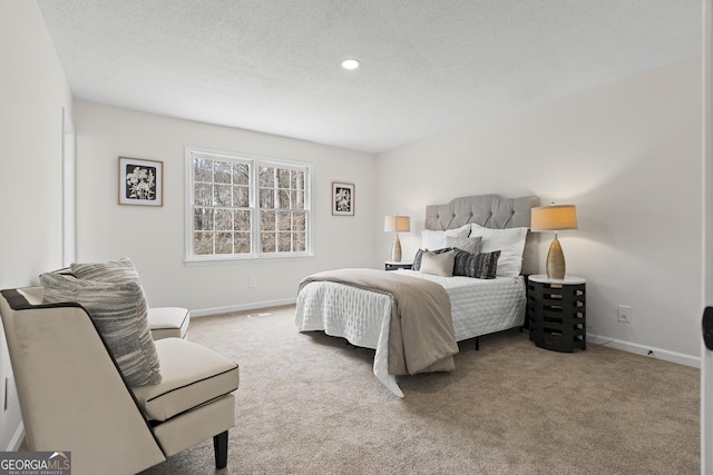 carpeted bedroom featuring baseboards, a textured ceiling, and recessed lighting