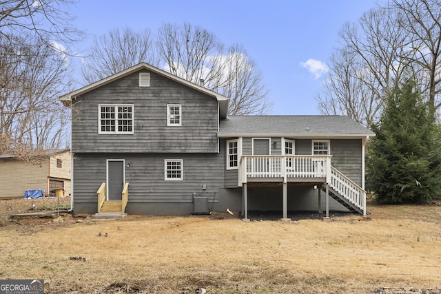 rear view of property with roof with shingles, central AC unit, entry steps, a wooden deck, and stairs